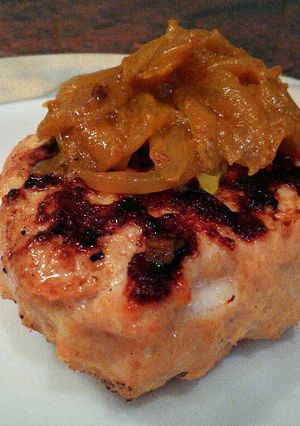 A picture of Goat cheese chicken burger with curried onions. .