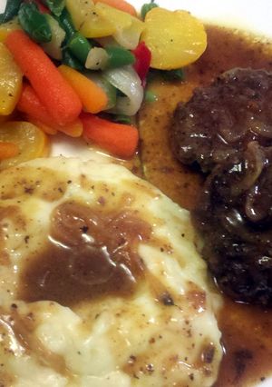 A picture of Hamburger Steak w/ Onions & Gravy.
