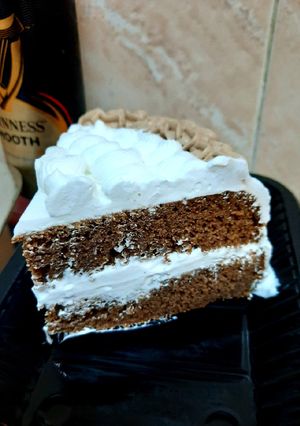 A picture of Chocolate Guinness cake with whipped cream icing.
