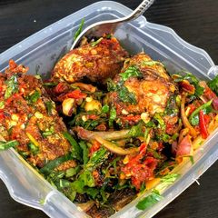 A picture of Boiled plantain and fish in green vegetable sauce.