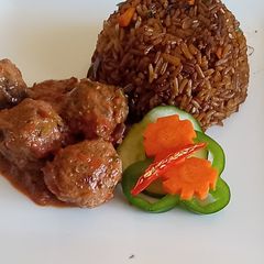 A picture of Meat balls in tomato Concasee' with stir fried rice.