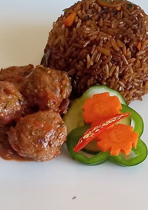 A picture of Meat balls in tomato Concasee' with stir fried rice.