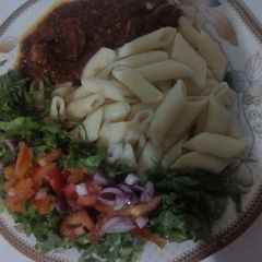 Macroni and stew with salad A picture of Macroni and stew with salad.