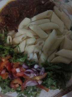 A picture of Macroni and stew with salad.