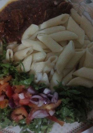 A picture of Macroni and stew with salad.