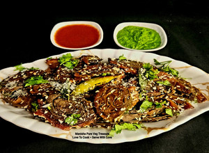 A picture of Alvi Pattarveliya Patra - Authentic Gujarati Snack - Colocasia Leaves Steamed Rolls.
