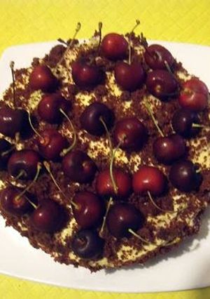 A picture of Red Velvet Cake with Orange Cream Cheese Icing and Cherries.