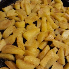 A picture of Roasted potatoes with bread crumb crust.