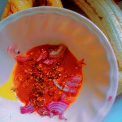 A picture of Roasted plantain with red oil.