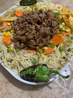 A picture of Herb spaghetti with Behari beef - western and desi fusion.
