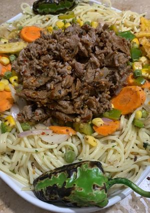 A picture of Herb spaghetti with Behari beef - western and desi fusion.