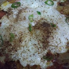 A picture of Poached Eggs with spicy Tomatoes and Potato.