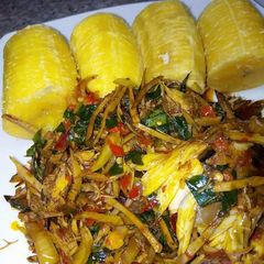 A picture of Ripe plantain with ugba sauce.