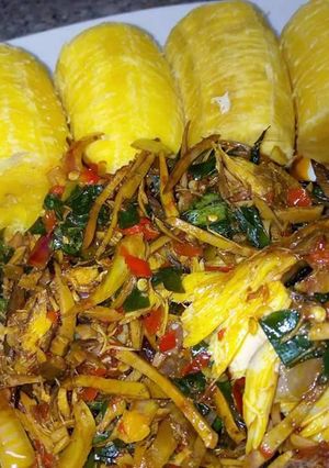 A picture of Ripe plantain with ugba sauce.