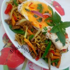 A picture of Aisha's Special stir fry noodles with minced meat and sunny side up egg.