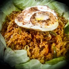 A picture of Triple Schezwan Fried Rice With Hot Sauce.