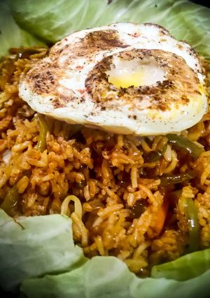 A picture of Triple Schezwan Fried Rice With Hot Sauce.