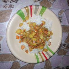 A picture of White rice with vegetable soup.