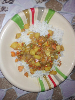 A picture of White rice with vegetable soup.