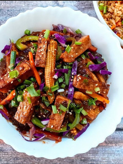 A picture of Tofu and stir fried vegetables in hot schezwan sauce.