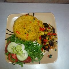 A picture of Jollof rice,Irish beef pepper & Lemon lettuce salad.