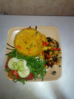 A picture of Jollof rice,Irish beef pepper & Lemon lettuce salad.