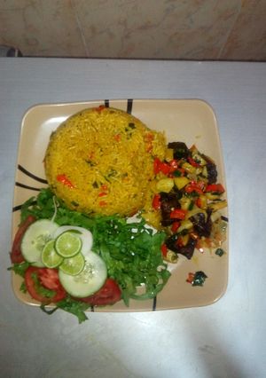 A picture of Jollof rice,Irish beef pepper & Lemon lettuce salad.
