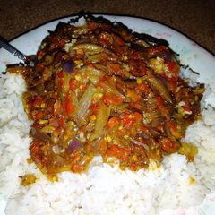 A picture of White rice with pepper sauce.