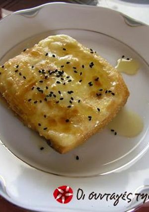 A picture of Filo wrapped feta cheese with honey sauce.