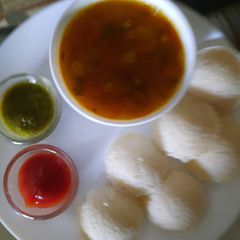 A picture of Rice Idli with Sambhar.