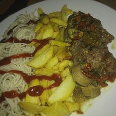 A picture of Pasta with fries and peppered meat sauce.