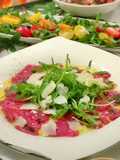 Beef Carpaccio with Arugula, pesto oil and truffle paste