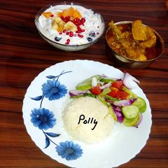 A picture of Rice chicken curry fruit raita.