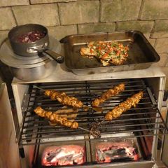 A picture of Chicken satay kebabs and home made pili pili cheesy chapati nachos in the jiko oven :).