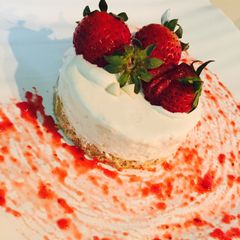 A picture of Cream cheese cake with strawberries.
