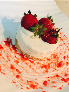 A picture of Cream cheese cake with strawberries.