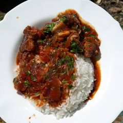 A picture of Rice served with stewed beef.