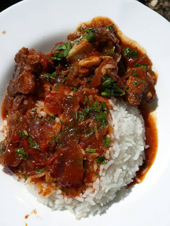 A picture of Rice served with stewed beef.