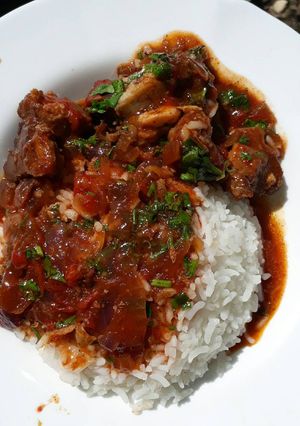 A picture of Rice served with stewed beef.