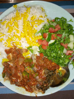 A picture of White rice,curried maca with fish stew and salad.
