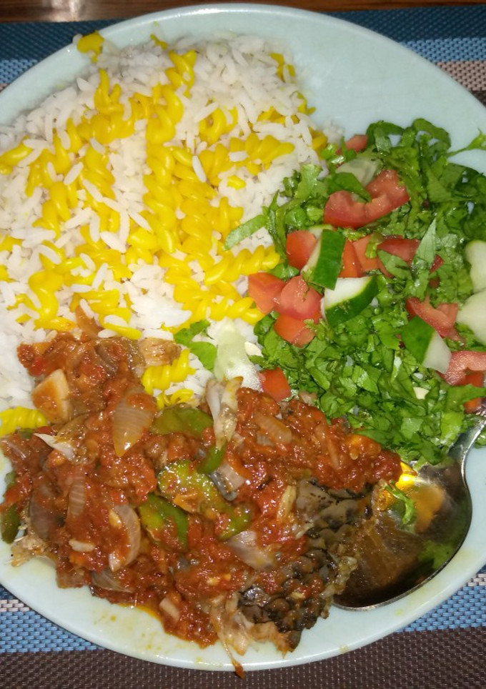 A picture of White rice,curried maca with fish stew and salad.