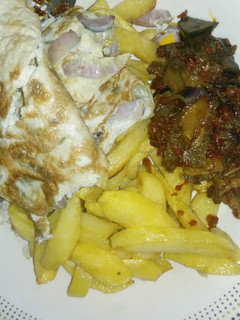 A picture of Chips, Egg and Assorted meat.