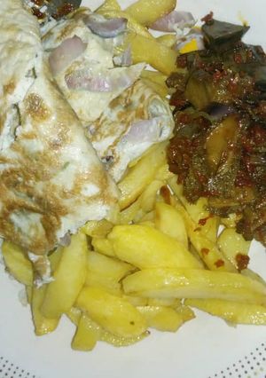 A picture of Chips, Egg and Assorted meat.