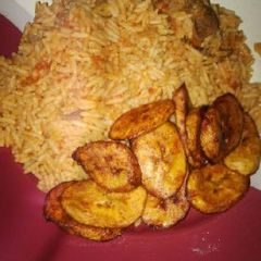 A picture of Jollof rice with fried plantain.