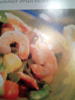 A picture of shrimp salad with warm bacon dressing.
