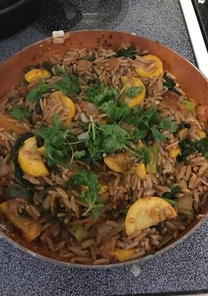 A picture of Vegan whole wheat orzo with yellow squash, spinach & jalapeños.