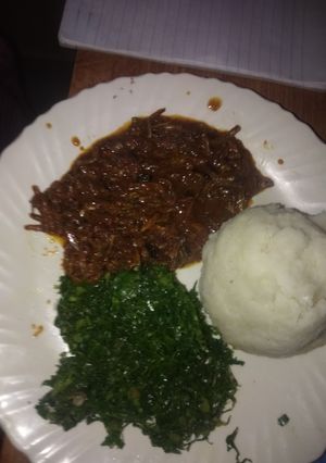 A picture of Omena stew with ugali and kales.