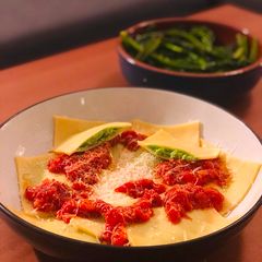 A picture of Cheats Pea and Ricotta Ravioli with Rich Tomato Sauce.