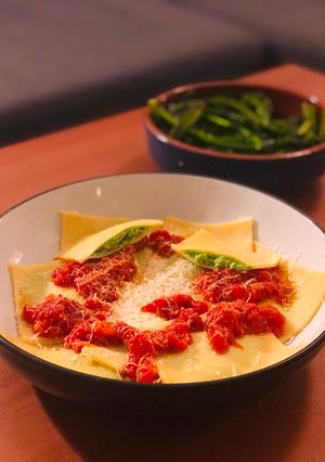 A picture of Cheats Pea and Ricotta Ravioli with Rich Tomato Sauce.