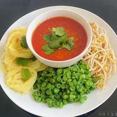 A picture of Rice vermicelli with Tuna Curry Sauce.